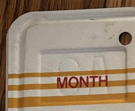 Closeup of month well in sunset plate with debossed CA